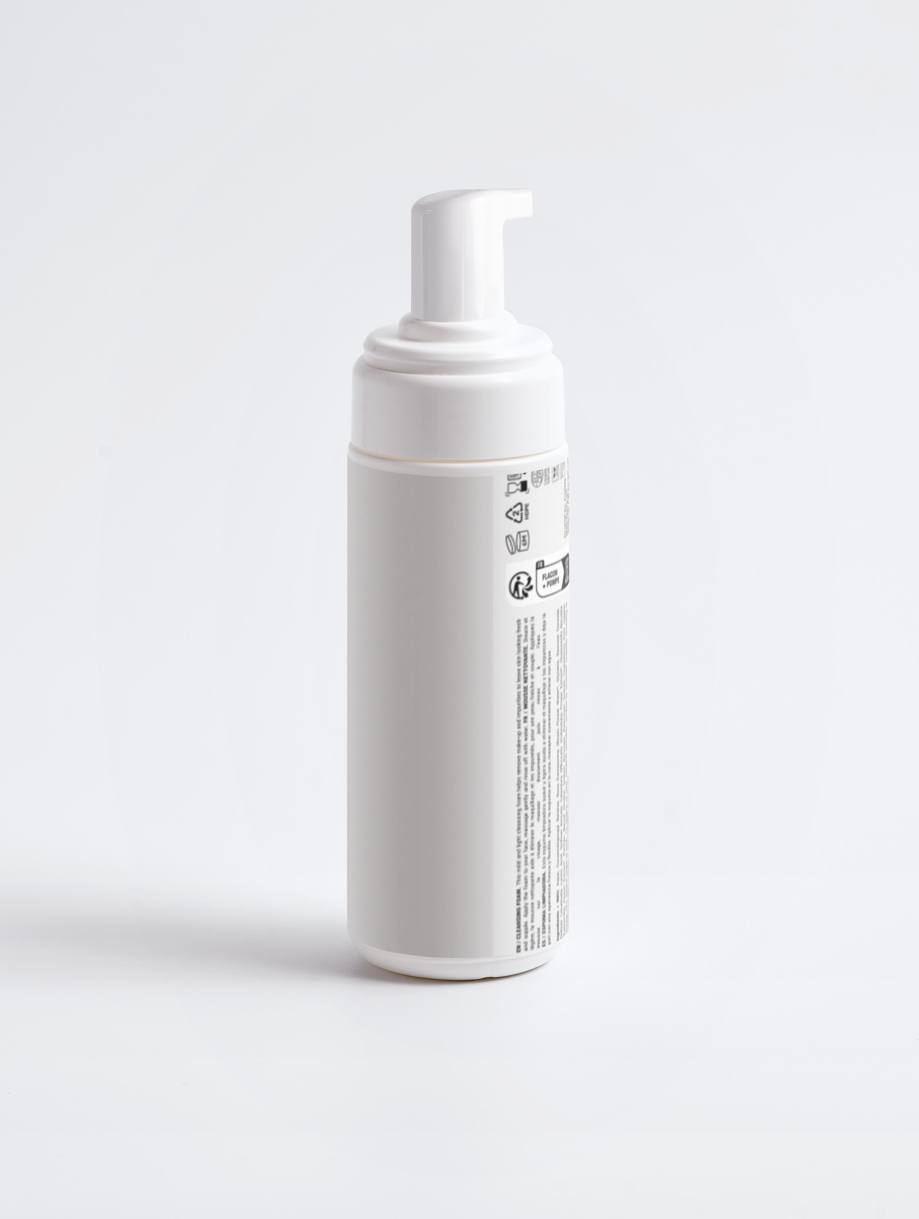 White foam bottle with text on a light gray background