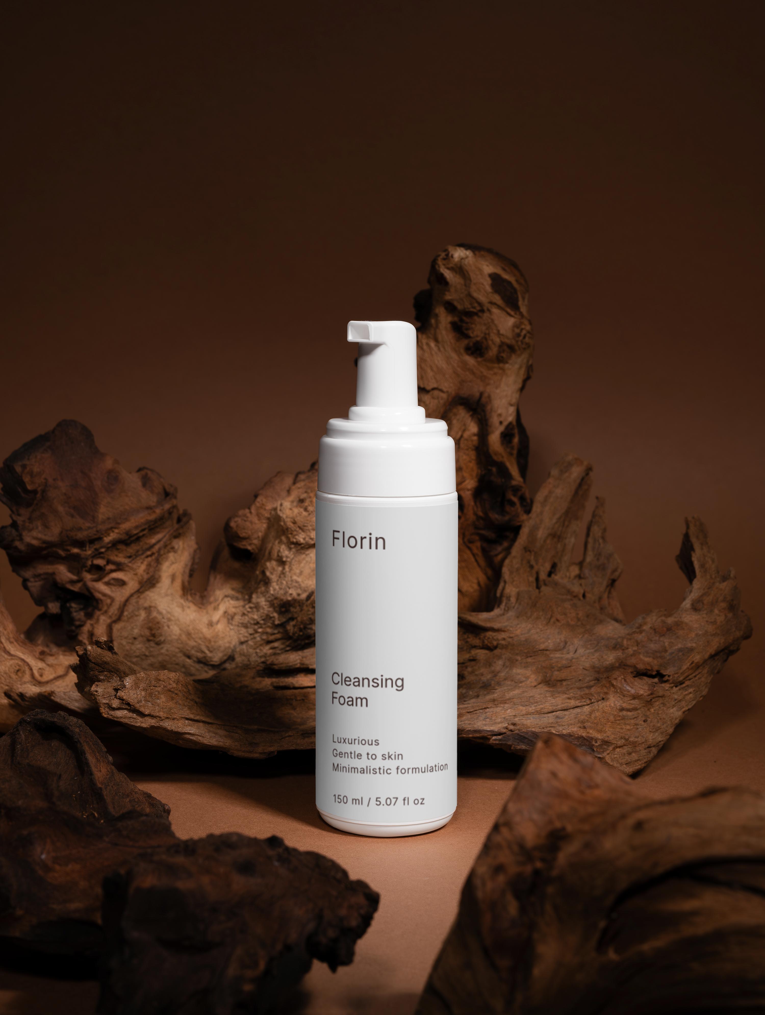 White bottle of Florin Cleansing Foam on a brown background with natural elements.