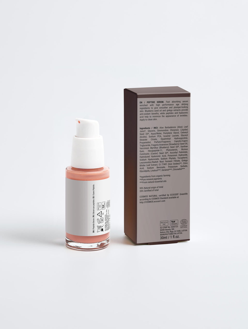 Skincare bottle with pink cap and white label next to its packaging on a light gray background
