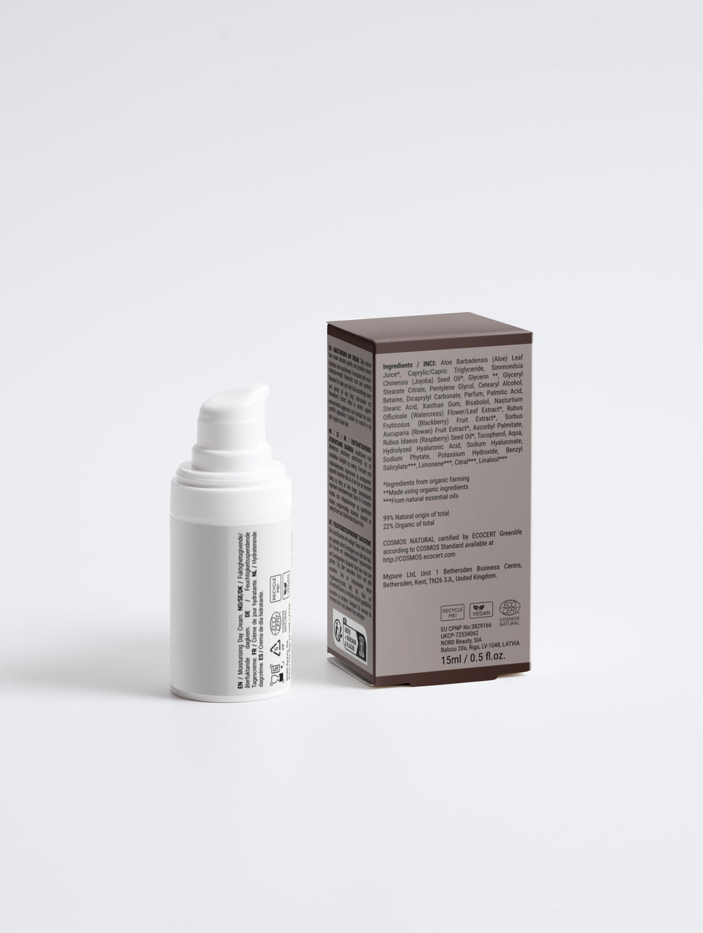 White skincare bottle with roller and brown box on a light gray background